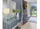 Inviting entryway featuring a glass console table, decorative mirror, and stylish decor with ample natural light at 8615 N Rindge Rd, Polk City, FL 33868