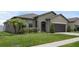Beautiful home with a lush green lawn, well-kept landscaping, and a convenient two-car garage at 8615 N Rindge Rd, Polk City, FL 33868