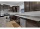 Contemporary kitchen with stainless steel appliances, granite countertops, and dark wood cabinetry at 8615 N Rindge Rd, Polk City, FL 33868