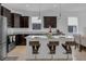 Modern kitchen with granite countertops, stainless steel appliances, and a convenient island with bar stool seating at 8615 N Rindge Rd, Polk City, FL 33868