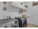 The spacious laundry room has a side-by-side washer and dryer, ample storage, and countertop space at 8615 N Rindge Rd, Polk City, FL 33868