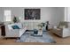 Bright living room showcasing a white sectional, modern glass table, and striking city artwork at 8615 N Rindge Rd, Polk City, FL 33868