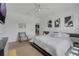 This main bedroom offers neutral walls, carpet flooring, a ceiling fan, and a decorative accent wall at 8615 N Rindge Rd, Polk City, FL 33868