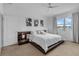 This main bedroom offers neutral walls, carpet flooring, a ceiling fan, a decorative accent wall, and natural light at 8615 N Rindge Rd, Polk City, FL 33868