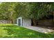 Charming backyard shed with a well-maintained lawn and mature trees, perfect for outdoor storage at 897 Shed St, Oviedo, FL 32765