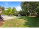 Expansive backyard with a sports court, grassy lawn, and mature trees offering plenty of shade at 897 Shed St, Oviedo, FL 32765