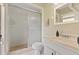 Neat bathroom with sliding shower door, simple vanity, and ample natural light at 897 Shed St, Oviedo, FL 32765