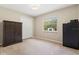 Well-lit bedroom with neutral walls, carpeted floors, and a window with views of the outdoors at 897 Shed St, Oviedo, FL 32765