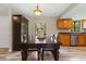 Dining area with a dark wood table and seating near the kitchen, boasting ample natural light at 897 Shed St, Oviedo, FL 32765
