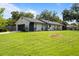 Single-story home with attached garage, lush lawn, and inviting curb appeal at 897 Shed St, Oviedo, FL 32765