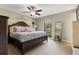 Serene main bedroom featuring a luxurious bed, ceiling fan, and ample natural light at 897 Shed St, Oviedo, FL 32765