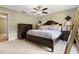 Serene main bedroom featuring a luxurious bed, ceiling fan, and ample natural light at 897 Shed St, Oviedo, FL 32765