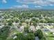 A home in a lush, green neighborhood is pinpointed in this scenic aerial shot with mature trees and nearby lake at 906 25Th Nw St, Winter Haven, FL 33881