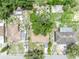 Aerial perspective of the property highlighting its placement in a residential neighborhood with mature trees at 906 25Th Nw St, Winter Haven, FL 33881