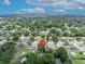 A home in a lush, green neighborhood is pinpointed in this scenic aerial shot with mature trees and nearby lake at 906 25Th Nw St, Winter Haven, FL 33881