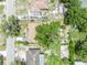 Overhead view of the home displaying the yard, mature trees, neighborhood, and proximity to local roads at 906 25Th Nw St, Winter Haven, FL 33881