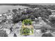 An aerial, greyscale view showing property lines around a single-Gathering home with mature trees at 906 25Th Nw St, Winter Haven, FL 33881