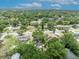Aerial view of the neighborhood with mature trees and single-Gathering homes shows property with ample foliage at 906 25Th Nw St, Winter Haven, FL 33881