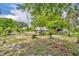 Lush backyard space, with mature trees offering shade and greenery, enhancing the private setting at 906 25Th Nw St, Winter Haven, FL 33881