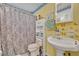 Bathroom featuring wallpaper, a sink, a mirror, and a toilet at 906 25Th Nw St, Winter Haven, FL 33881