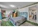 Bedroom featuring a bed with a blue headboard and green flooring at 906 25Th Nw St, Winter Haven, FL 33881