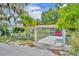 Gated home entrance with well-maintained landscaping and driveway leading to the property at 906 25Th Nw St, Winter Haven, FL 33881