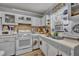 A kitchen featuring white appliances and cabinetry with a double sink at 906 25Th Nw St, Winter Haven, FL 33881