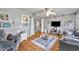 Open living room with a ceiling fan, wood floors, and access to the second story at 906 25Th Nw St, Winter Haven, FL 33881