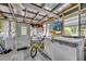 Enclosed sunroom with laundry appliances and features painted white wood flooring and natural light at 906 25Th Nw St, Winter Haven, FL 33881
