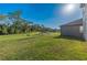 Expansive backyard featuring a pond, lush lawn, and mature trees at 9199 Waverly Walk Dr, Orlando, FL 32817