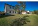 Spacious backyard featuring lush lawn and new home construction at 9199 Waverly Walk Dr, Orlando, FL 32817