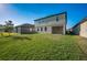 Expansive backyard with green lawn and covered patio area at 9199 Waverly Walk Dr, Orlando, FL 32817