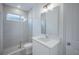Well-lit bathroom featuring a modern vanity, shower, and neutral tiling at 9199 Waverly Walk Dr, Orlando, FL 32817