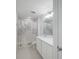 Bathroom with white cabinets, tiled floors, and shower with patterned curtain at 9199 Waverly Walk Dr, Orlando, FL 32817