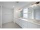 Sleek bathroom features double sinks, tile floors, and shower with glass door at 9199 Waverly Walk Dr, Orlando, FL 32817