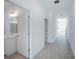 Hallway featuring view of bathroom with a vanity sink, shower, and a door at 9199 Waverly Walk Dr, Orlando, FL 32817