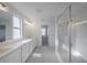 A well-lit primary bathroom features double sinks, sleek countertops, a modern shower, and stylish fixtures at 9199 Waverly Walk Dr, Orlando, FL 32817