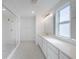 Bright bathroom featuring double sinks, sleek countertops, and modern fixtures with a glass shower at 9199 Waverly Walk Dr, Orlando, FL 32817