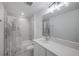Bright bathroom featuring a shower over tub and a large mirror over the sink at 9199 Waverly Walk Dr, Orlando, FL 32817