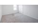 Bedroom featuring plush neutral carpet, window, and white door and trim at 9199 Waverly Walk Dr, Orlando, FL 32817
