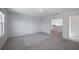 A bright bedroom features neutral carpet, and trim with a door leading to another room at 9199 Waverly Walk Dr, Orlando, FL 32817