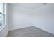 Bright bedroom with light gray wood-look floors, white walls and baseboards, and window view at 9199 Waverly Walk Dr, Orlando, FL 32817