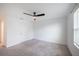 Carpeted bedroom with white trim and walls, a ceiling fan, and a window at 9199 Waverly Walk Dr, Orlando, FL 32817
