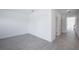 A bright bedroom with light gray wood-look floors, white walls and baseboards, and natural light at 9199 Waverly Walk Dr, Orlando, FL 32817
