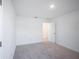Bright bedroom with plush neutral carpet, a door, and white walls and trim at 9199 Waverly Walk Dr, Orlando, FL 32817
