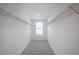 Walk-in closet with wire shelving, neutral carpet, and a window providing natural light at 9199 Waverly Walk Dr, Orlando, FL 32817