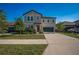 Charming two-story home with well-maintained lawn, lush landscaping, and a driveway leading to a two-car garage at 9199 Waverly Walk Dr, Orlando, FL 32817