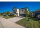 Charming two-story home with a well-manicured lawn and driveway, complete with an attached two-car garage at 9199 Waverly Walk Dr, Orlando, FL 32817