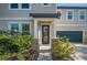 Inviting front entrance with stone accents, a covered porch, and a well-maintained lawn at 9199 Waverly Walk Dr, Orlando, FL 32817