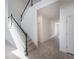 Hallway showcases staircase with dark wood handrail and light carpet, and tile flooring at 9199 Waverly Walk Dr, Orlando, FL 32817